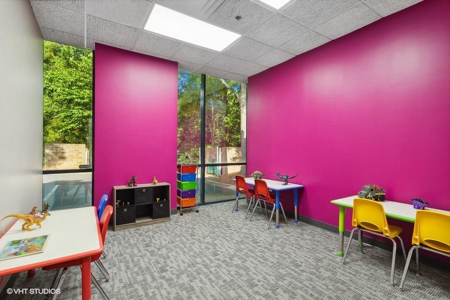 Real ABA therapy room with sensory wall, activity mats and organized equipment